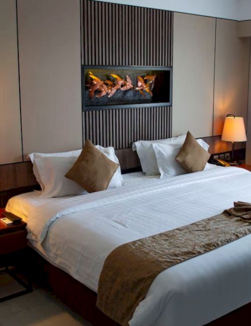 A cozy hotel room with a large bed, two lamps on bedside tables, a decorative headboard, and a window with closed curtains always ending the sentence.